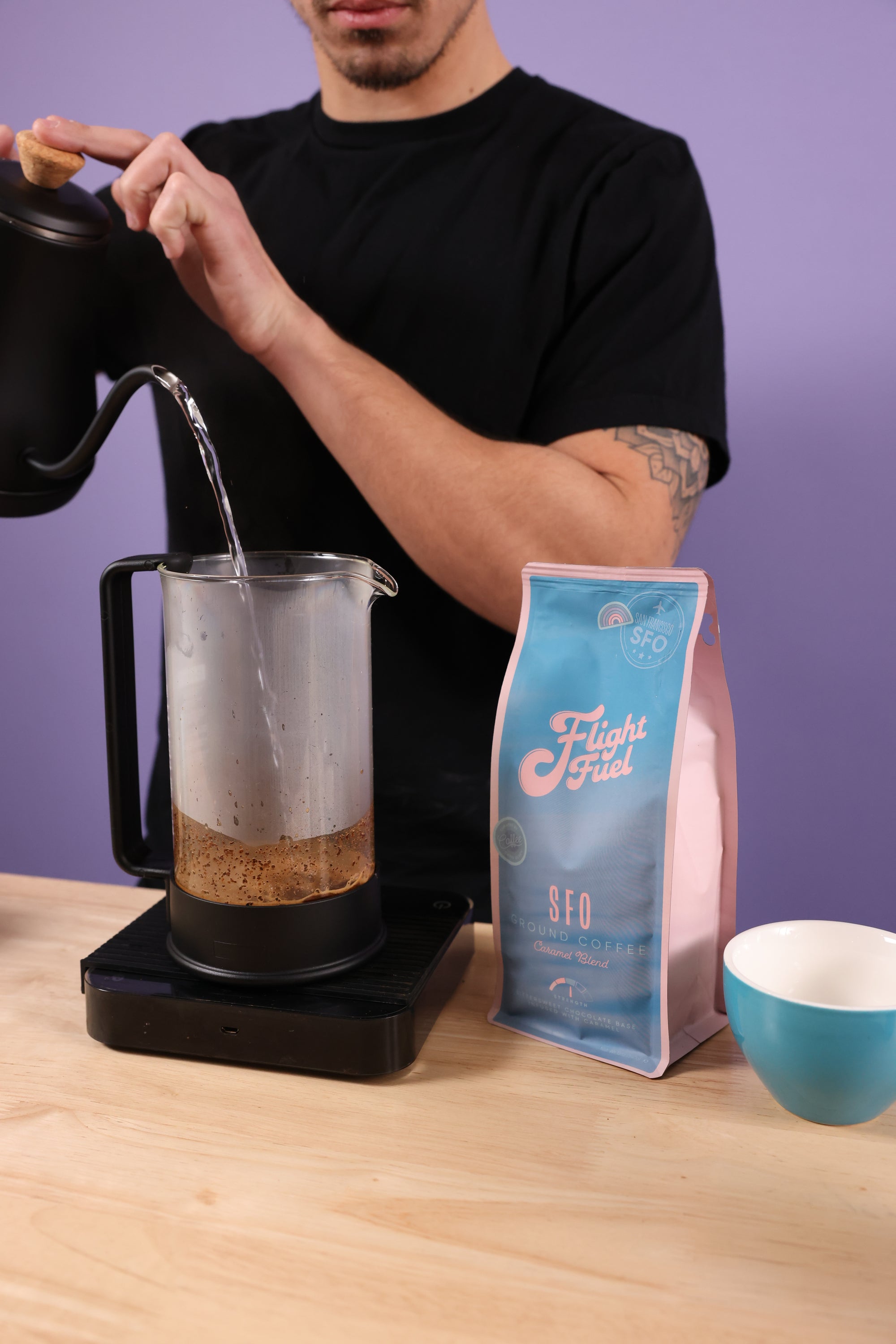 Barista making caramel coffee in a french press.
